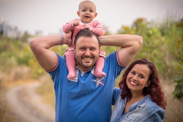 A cheerful family of three, enjoying a day outdoors. Perfect for family, happiness, and togetherness concepts.